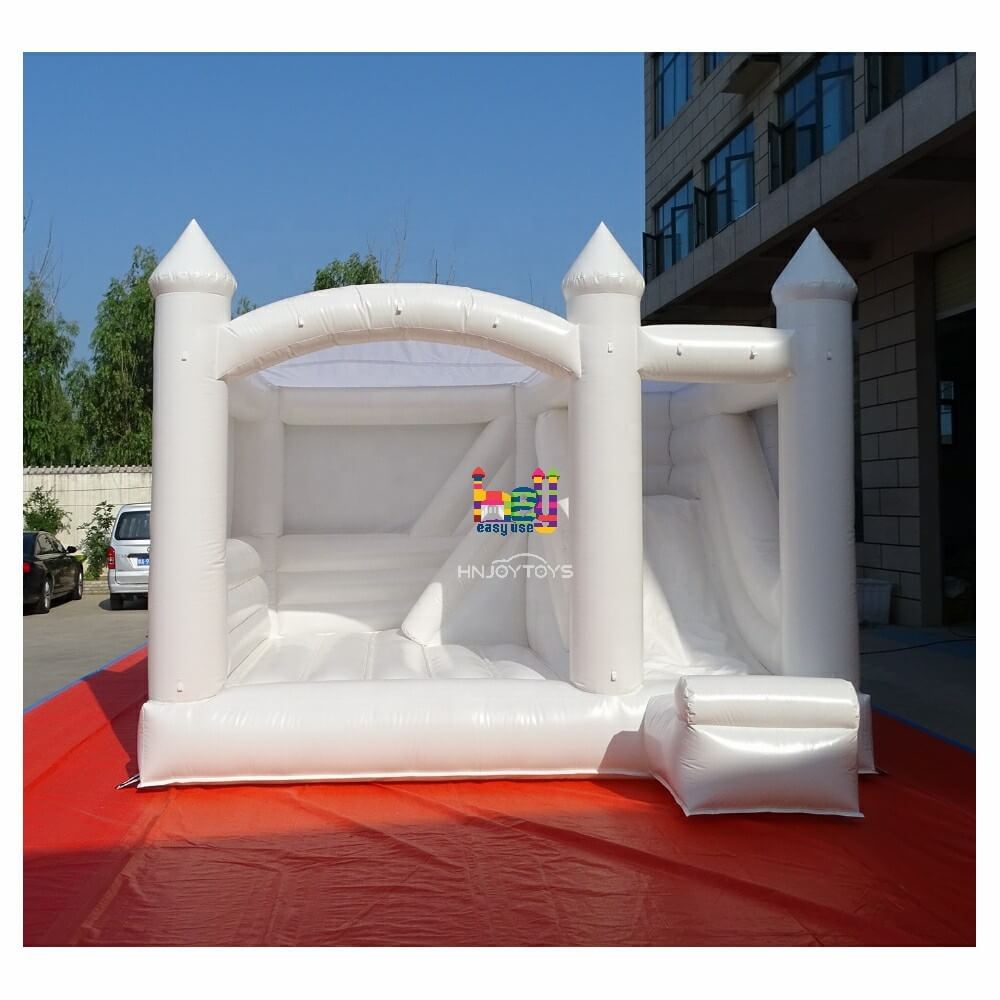white bounce house with slide with air blower