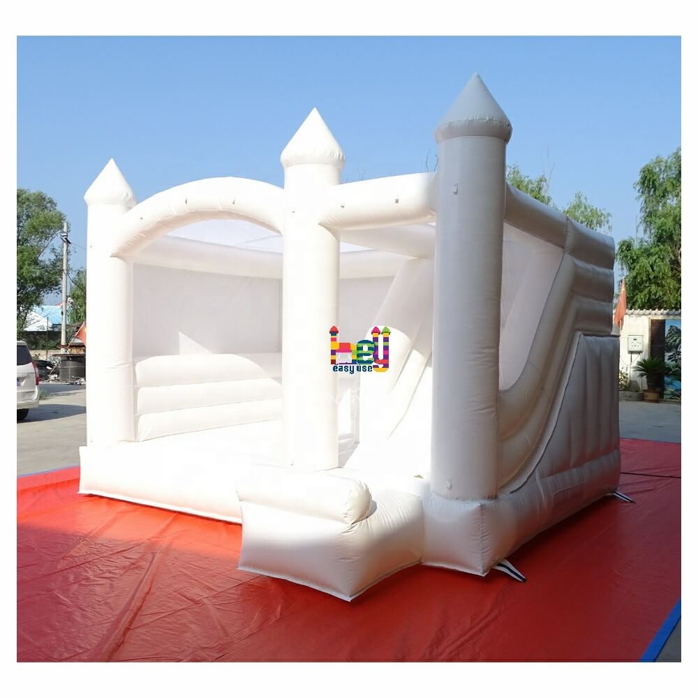 white bounce house with slide with air blower