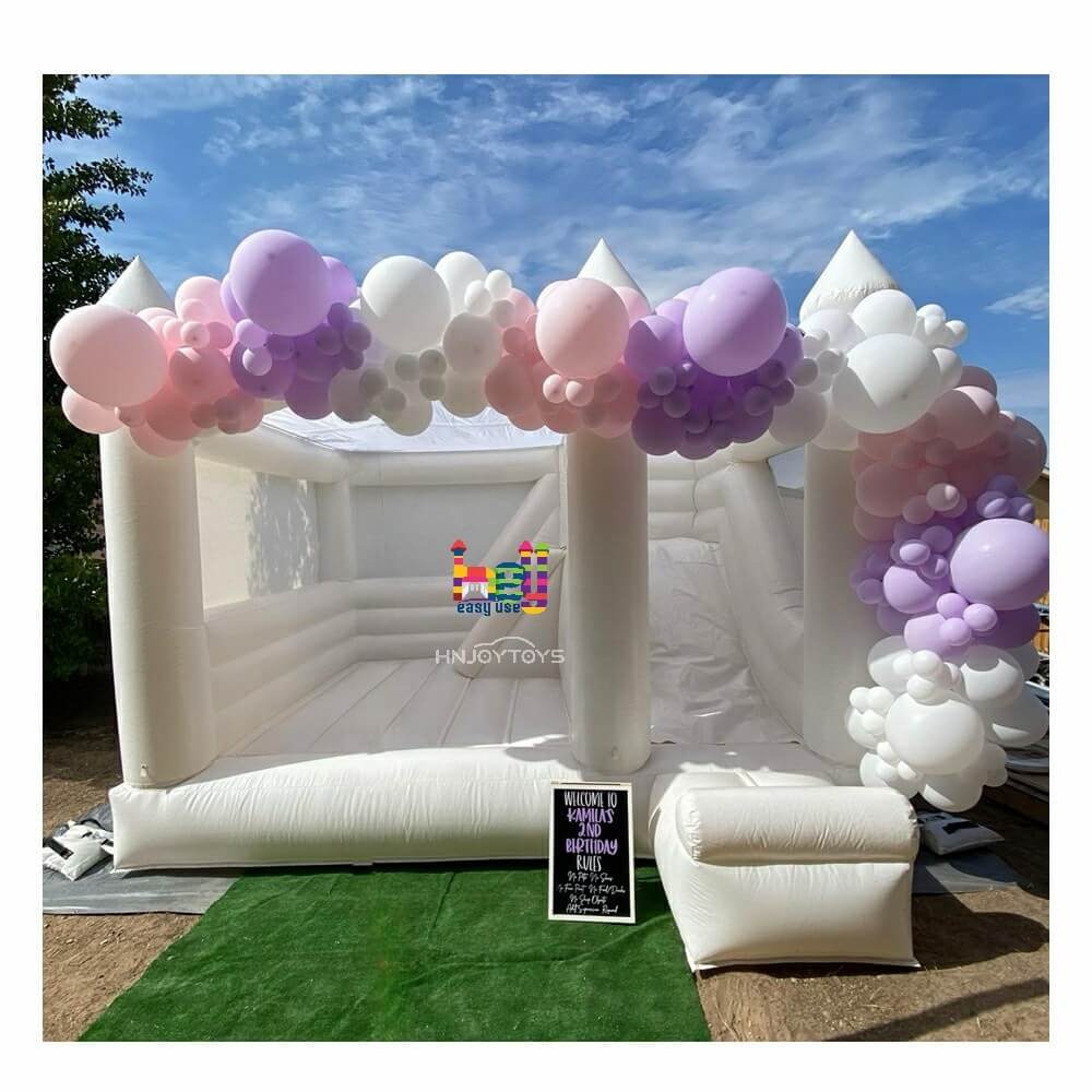 white bounce house with slide with air blower