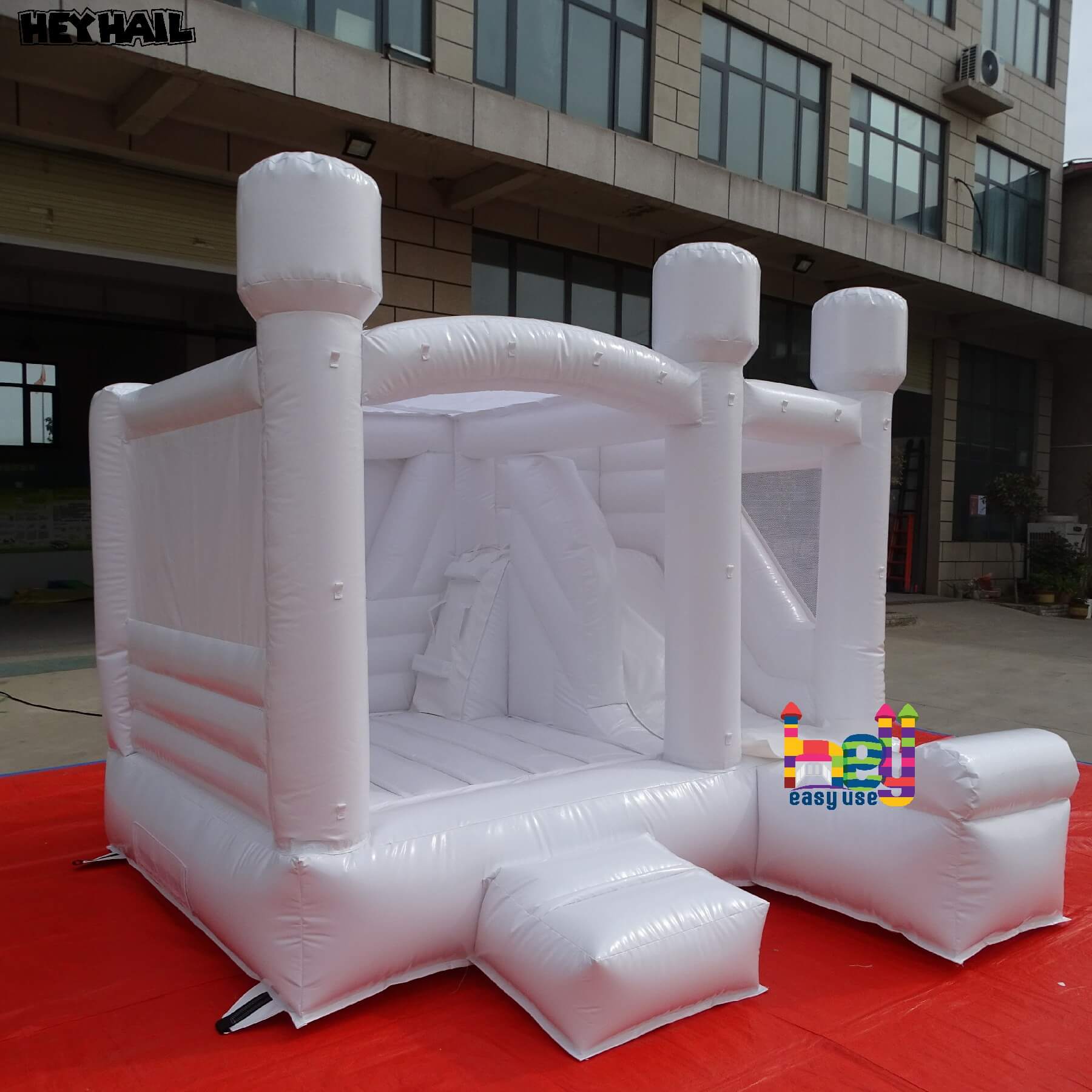 white bouncy castle with balloons