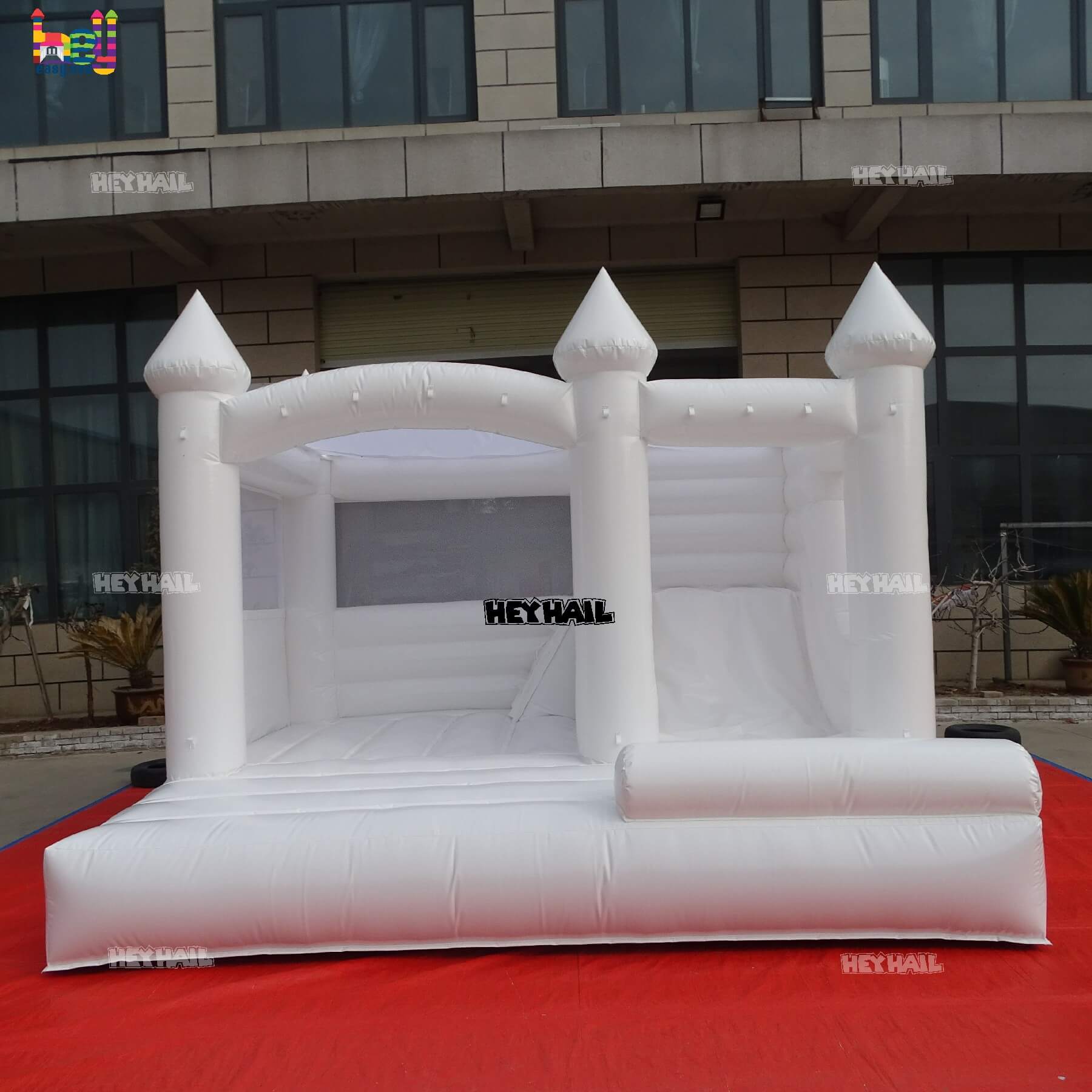 commercial glossy white bounce house with slide