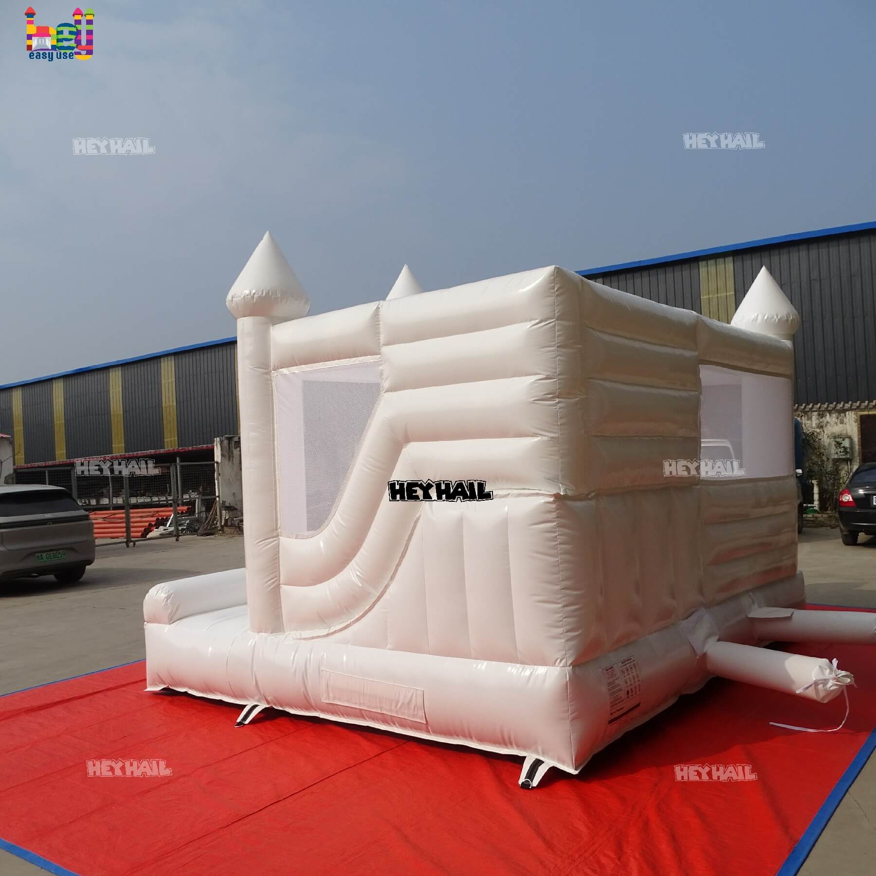 commercial glossy white bounce house with slide