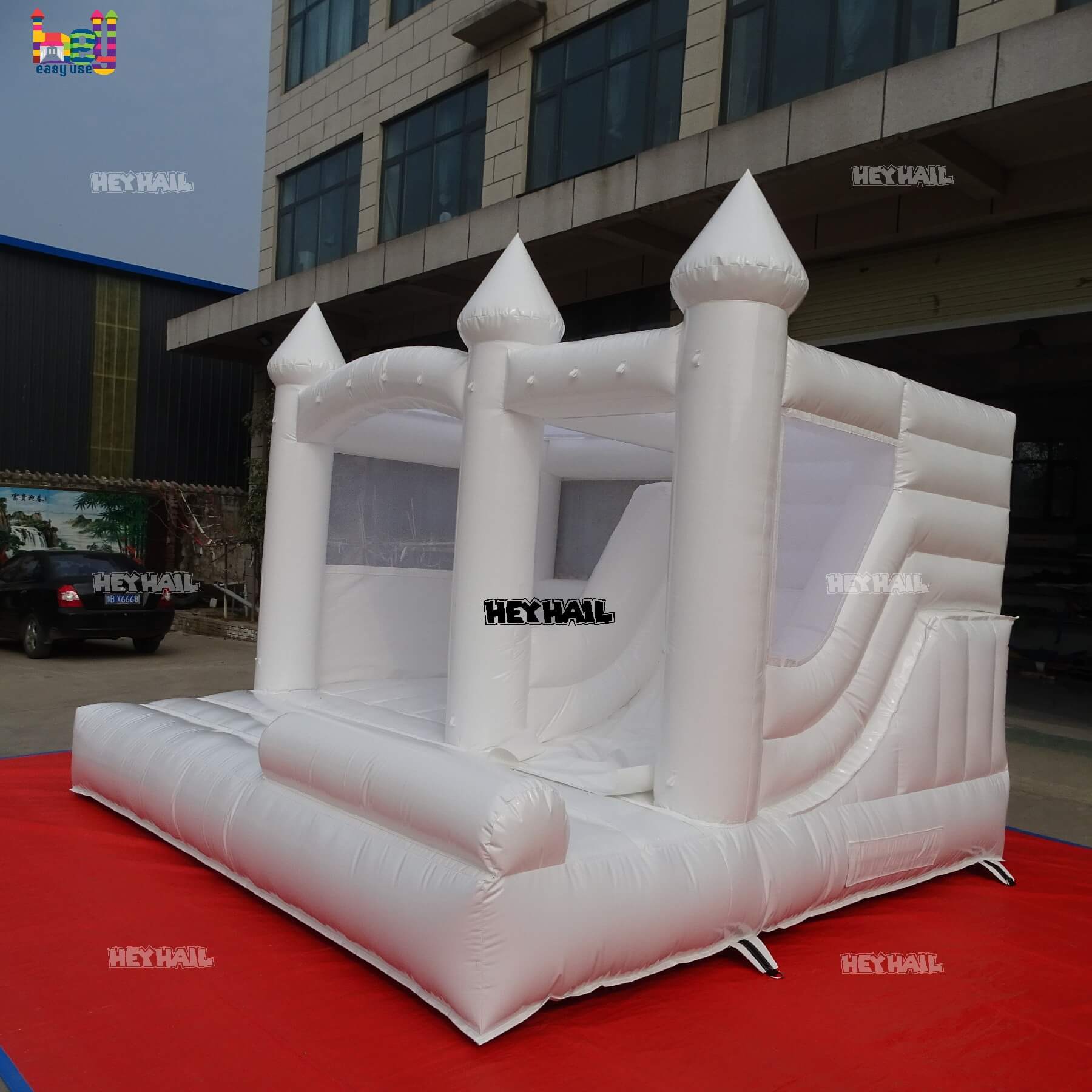 commercial glossy white bounce house with slide