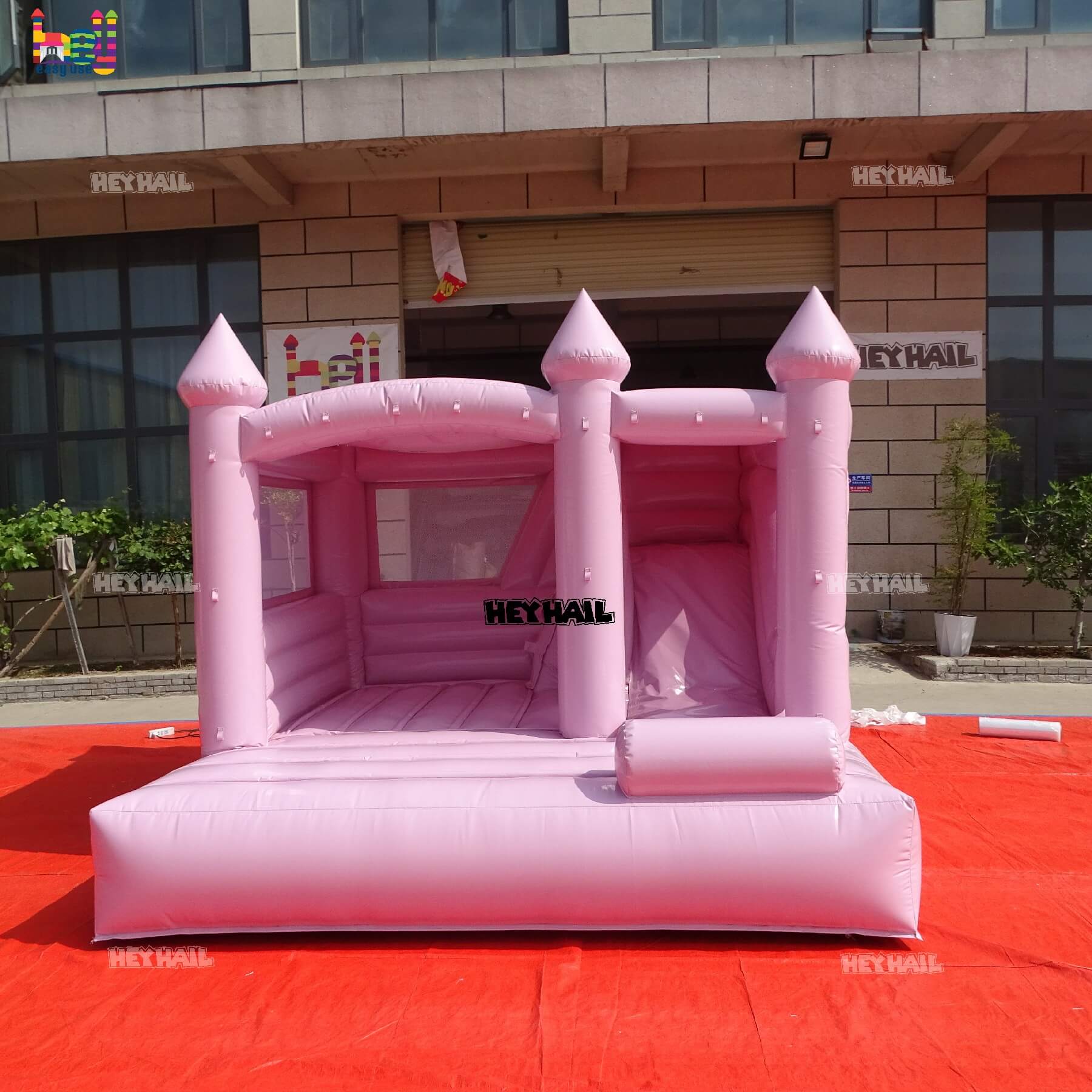outdoor pastel pink bounce house with slide on sale