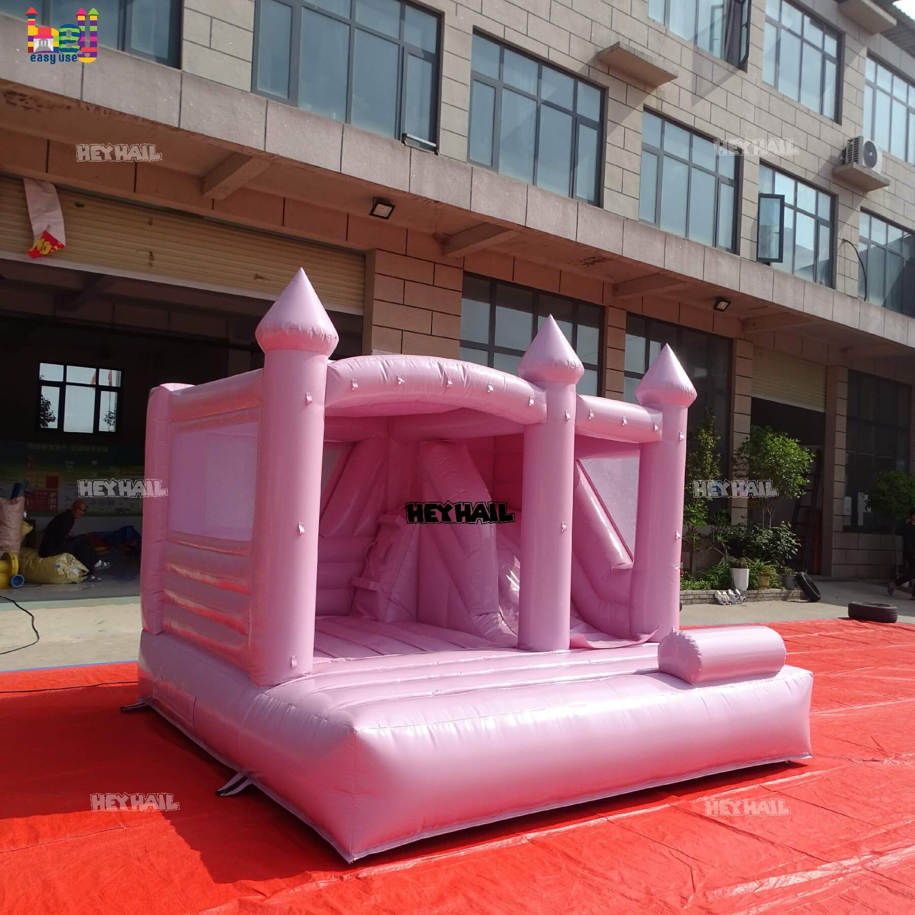 outdoor pastel pink bounce house with slide on sale