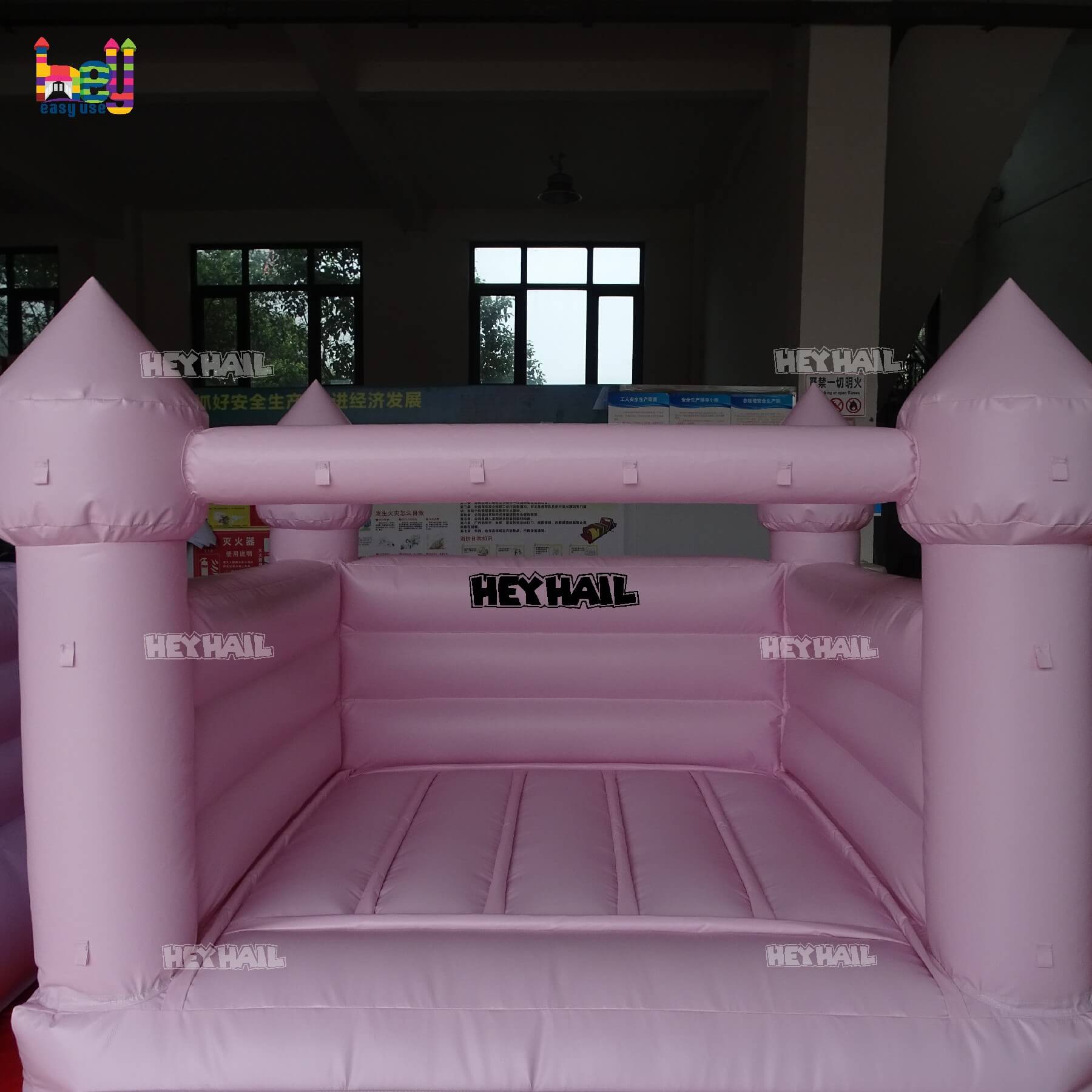 commercial light pastel pink bounce house on promotion