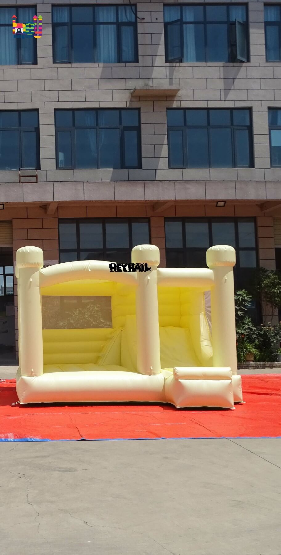 inflatable pastel yellow bounce house with slide