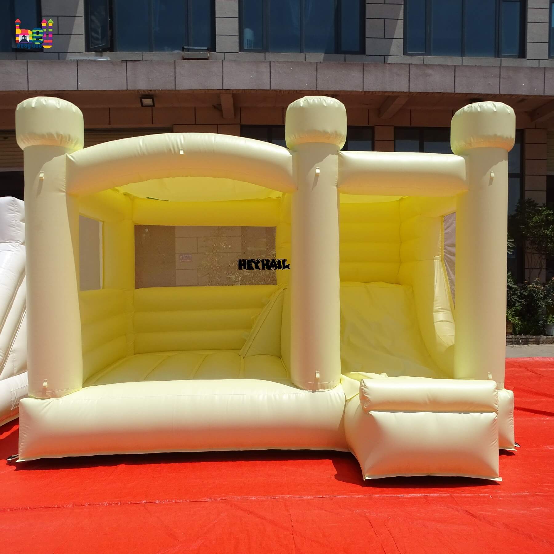 inflatable pastel yellow bounce house with slide